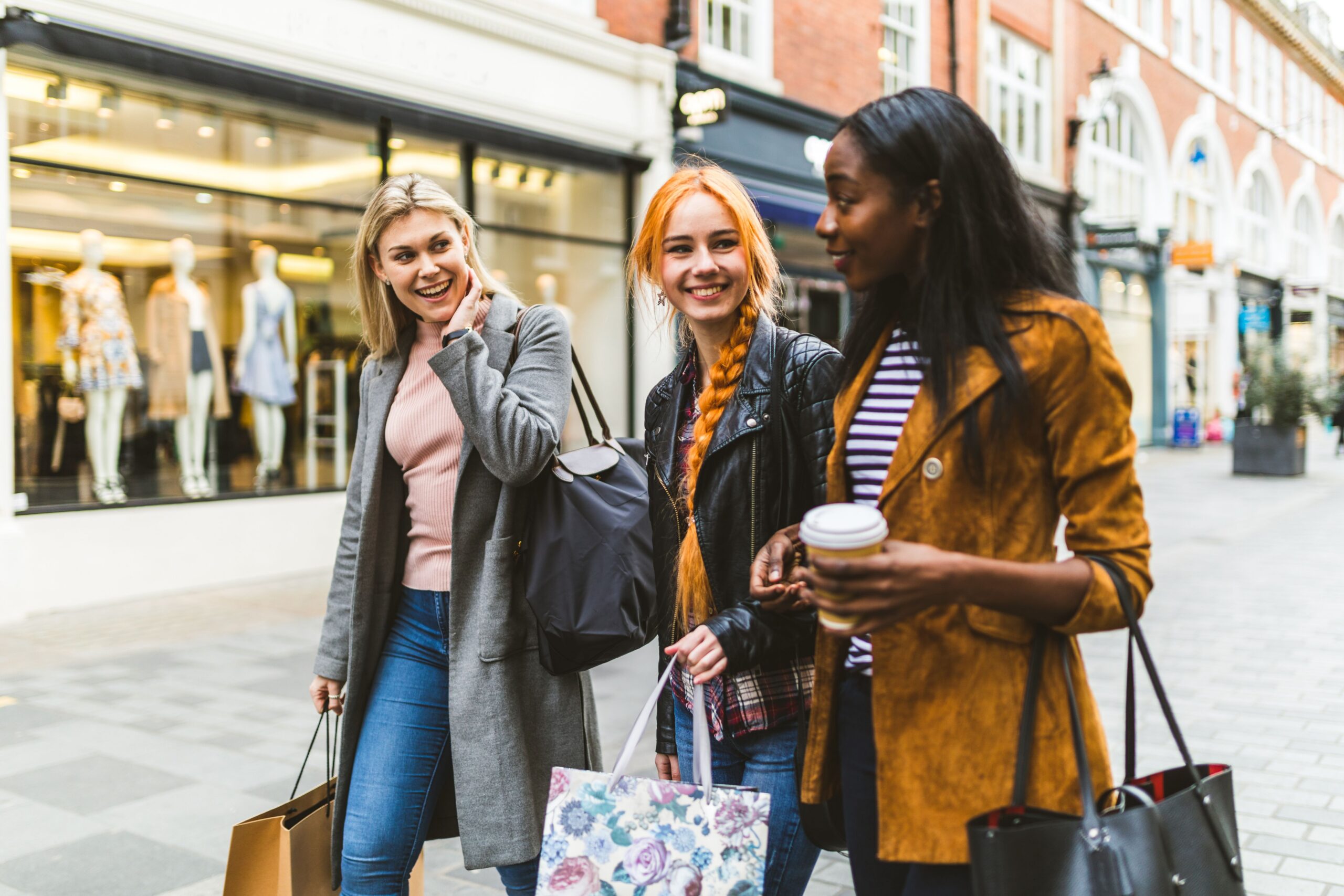 friends walking urban shopping district scaled